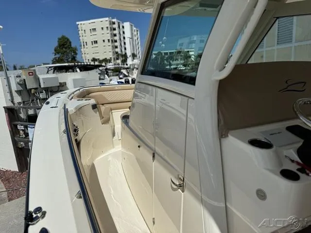 Slide: The Image of 2022 Scout 330 LXF boat docked at marina, side view. - 47