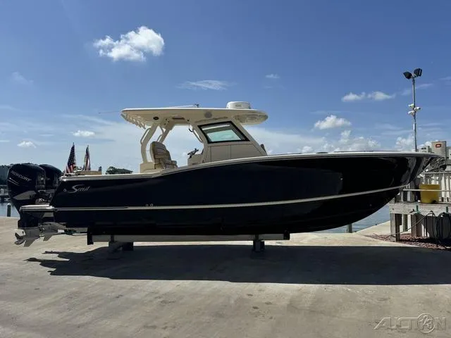 Slide: The Image of 2022 Scout 330 LXF boat docked under a clear blue sky. - 5