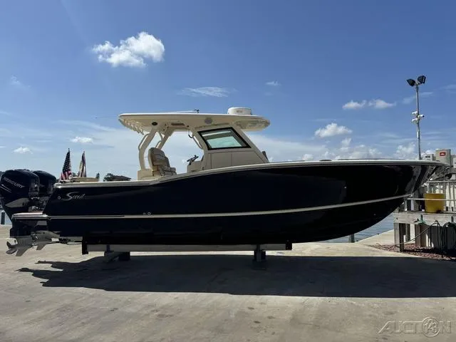 Slide: The Image of 2022 Scout 330 LXF boat docked under a clear blue sky. - 6