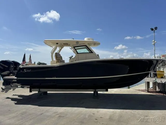 Slide: The Image of 2022 Scout 330 LXF boat on a dock under a clear blue sky. - 8