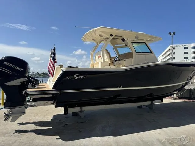 Slide: The Image of 2022 Scout 330 LXF boat with Mercury engine, docked at marina. - 9