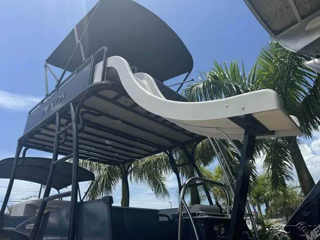 Slide: The Image of 2024 Avalon Catalina Entertainer Funship 27 FT with slide, palm trees in background. - 17