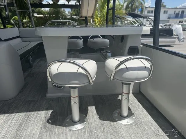 Slide: The Image of 2024 Avalon Catalina Entertainer Funship 27 FT interior with bar stools and seating area. - 32