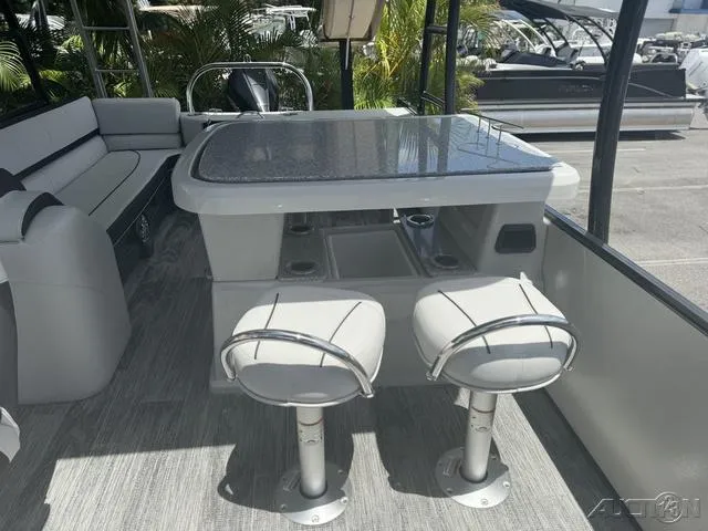 Slide: The Image of 2024 Avalon Catalina Entertainer Funship 27 FT interior with bar stools and table. - 33