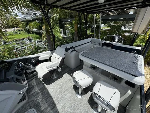 Slide: The Image of 2024 Avalon Catalina Entertainer Funship 27 FT interior with seating and table. - 35