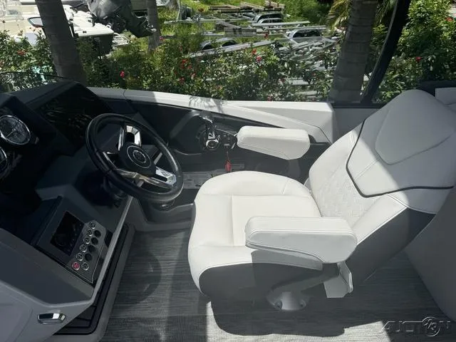 Slide: The Image of 2024 Avalon Catalina Entertainer Funship 27 FT boat cockpit with steering wheel and captain's chair. - 37