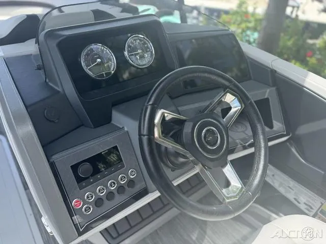 Slide: The Image of 2024 Avalon Catalina Entertainer Funship 27 FT boat dashboard with steering wheel and control panel. - 38