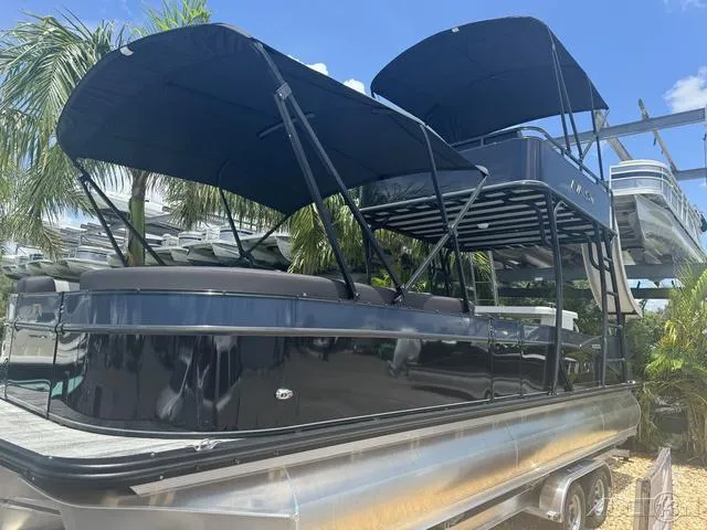 Slide: The Image of 2024 Avalon Catalina Entertainer Funship 27 FT pontoon boat with black canopy. - 4