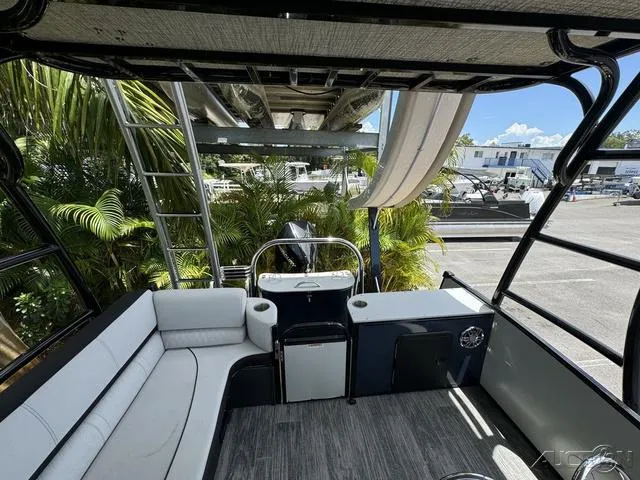 Slide: The Image of 2024 Avalon Catalina Entertainer Funship 27 FT interior with seating and ladder. - 45