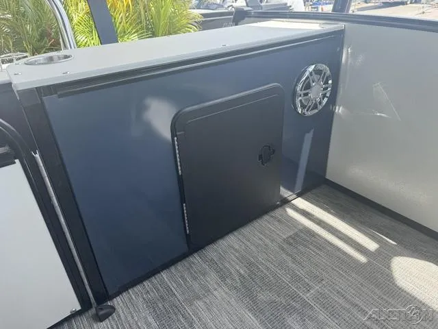 Slide: The Image of 2024 Avalon Catalina Entertainer Funship 27 FT interior detail with storage compartment and speaker. - 47