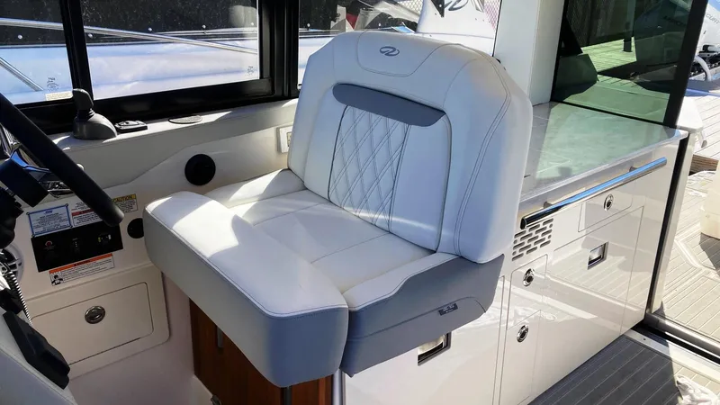 Slide: The Image of 2025 Regal 36 Grande Coupe helm with modern controls and luxurious seating. - 13