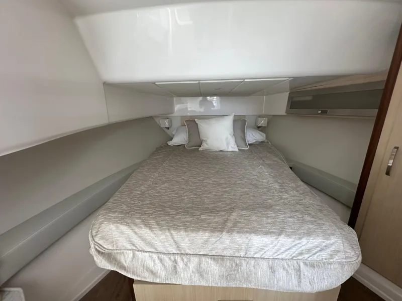 Slide: The Image of 2025 Regal 36 Grande Coupe interior with sleek cabinetry and modern design. - 17