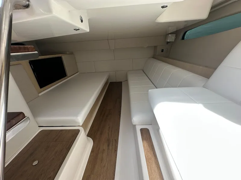 Slide: The Image of 2025 Regal 36 Grande Coupe helm seat with luxurious white upholstery. - 19