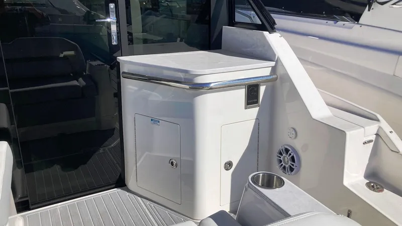 Slide: The Image of 2025 Regal 36 Grande Coupe yacht interior with sleek white cabinetry and modern design. - 3