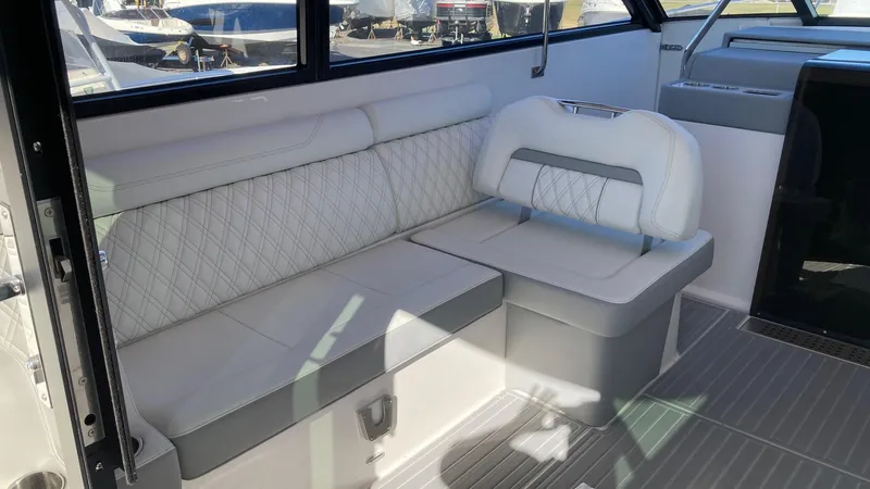 Slide: The Image of 2025 Regal 36 Grande Coupe interior with helm and seating area. - 7