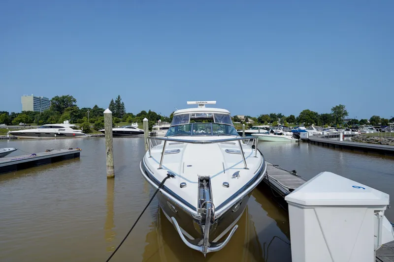 Slide: The Image of 2017 Formula 370 Super Sport boat docked in a marina under clear blue sky. - 15