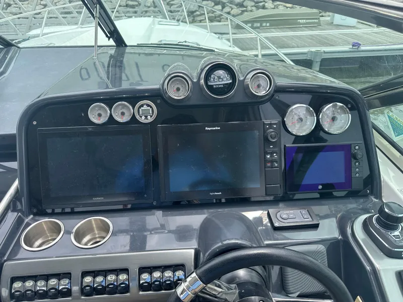 Slide: The Image of Dashboard of a 2017 Formula 370 Super Sport boat with navigation screens and controls. - 24