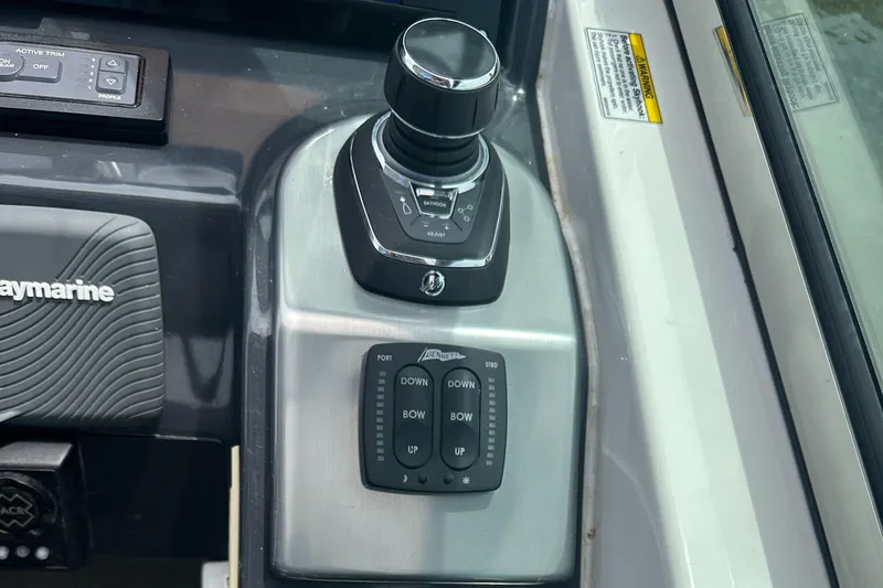Slide: The Image of Control panel of a 2017 Formula 370 Super Sport boat with joystick and trim controls. - 25