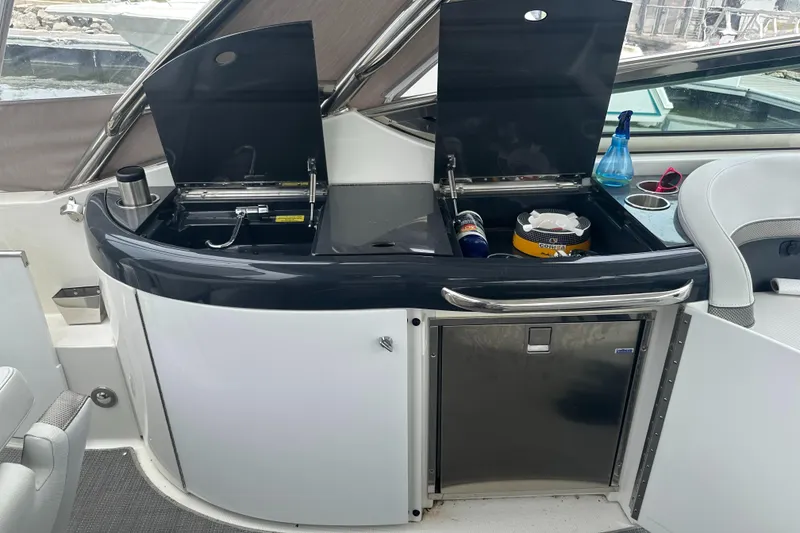 Slide: The Image of 2017 Formula 370 Super Sport yacht interior with kitchenette and storage compartments. - 29