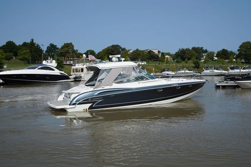 Slide: The Image of 2017 Formula 370 Super Sport boat docked in a marina, surrounded by other vessels. - 3
