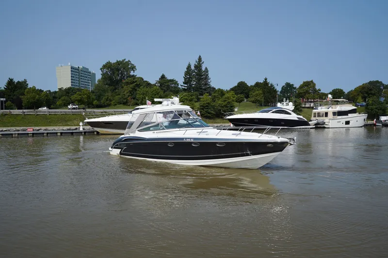 Slide: The Image of 2017 Formula 370 Super Sport yacht cruising on a calm river near a marina. - 4