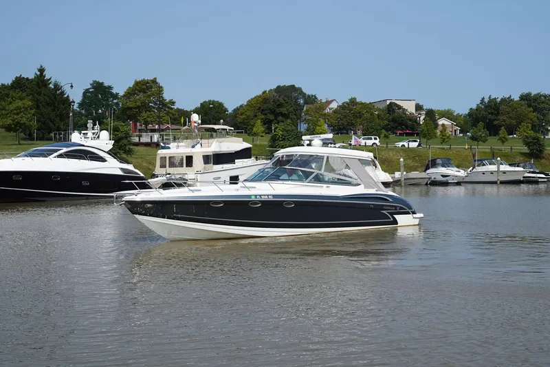 Slide: The Image of 2017 Formula 370 Super Sport boat cruising on a calm river with other boats nearby. - 7