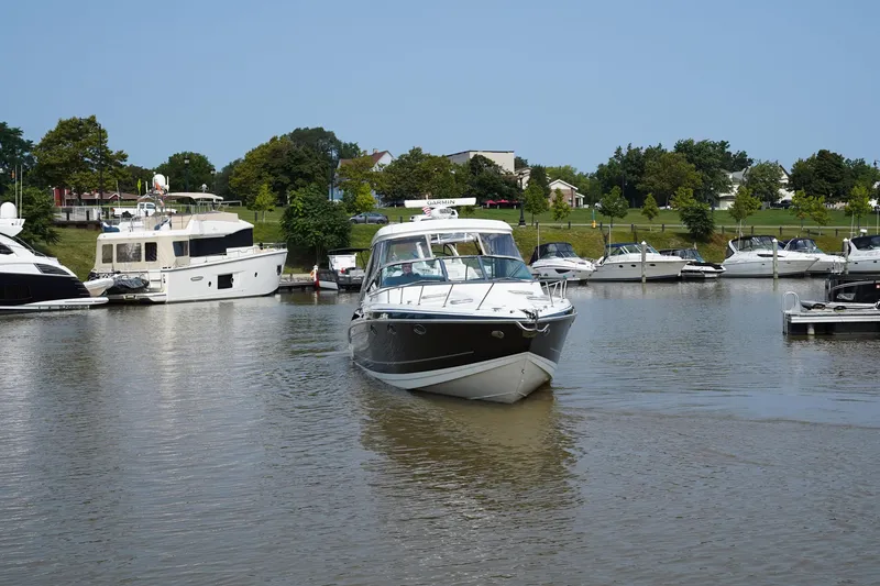 Slide: The Image of 2017 Formula 370 Super Sport boat cruising in a marina with other yachts. - 8