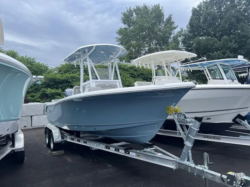 Slide: The Image of 2025 Sea Hunt Ultra 219 boat on a trailer, displayed outdoors. - 18