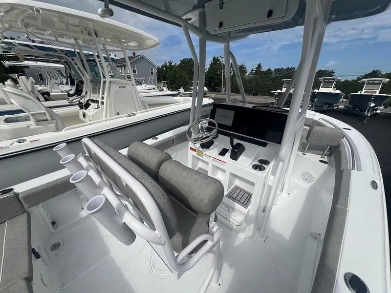 Slide: The Image of 2025 Sea Hunt Ultra 219 boat interior with helm station and seating. - 2