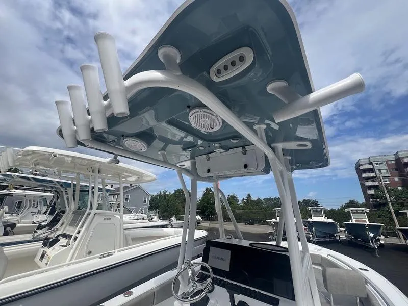 Slide: The Image of 2025 Sea Hunt Ultra 219 boat with T-top and rod holders in marina. - 8