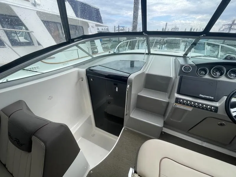 Slide: The Image of Interior helm of 2014 Sea Ray 310 Sundancer with modern controls and seating. - 11