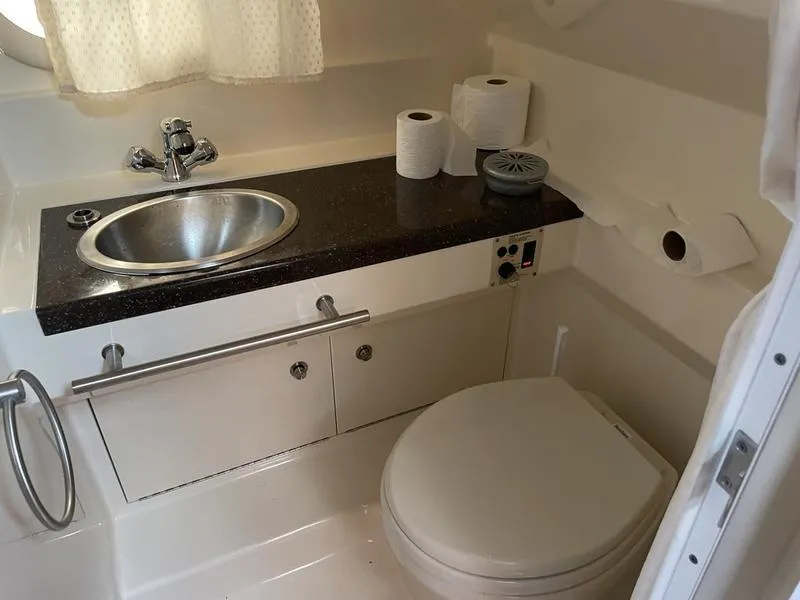 Slide: The Image of 2014 Sea Ray 310 Sundancer bathroom with sink, toilet, and countertop. - 2
