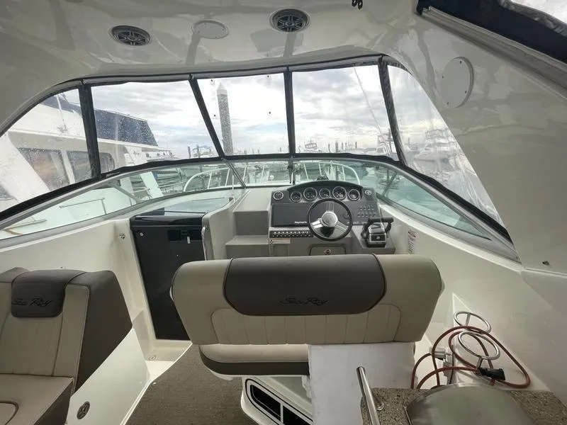 Slide: The Image of 2014 Sea Ray 310 Sundancer cockpit with steering wheel and dashboard. - 5
