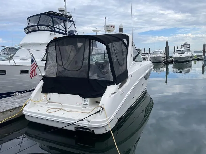 Slide: The Image of 2014 Sea Ray 310 Sundancer docked at marina with other boats. - 8