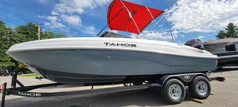 Slide: The Image of 2024 Tahoe T21 boat with red canopy on trailer under blue sky. - 7