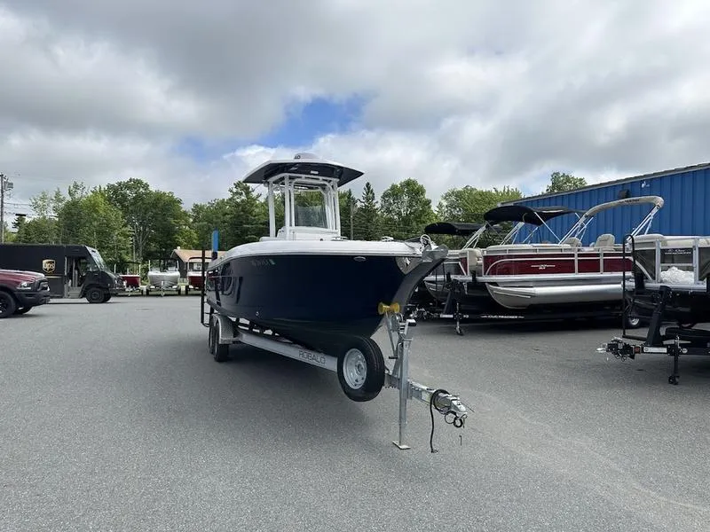 Slide: The Image of 2022 Robalo R242 boat on a trailer in a parking lot. - 11