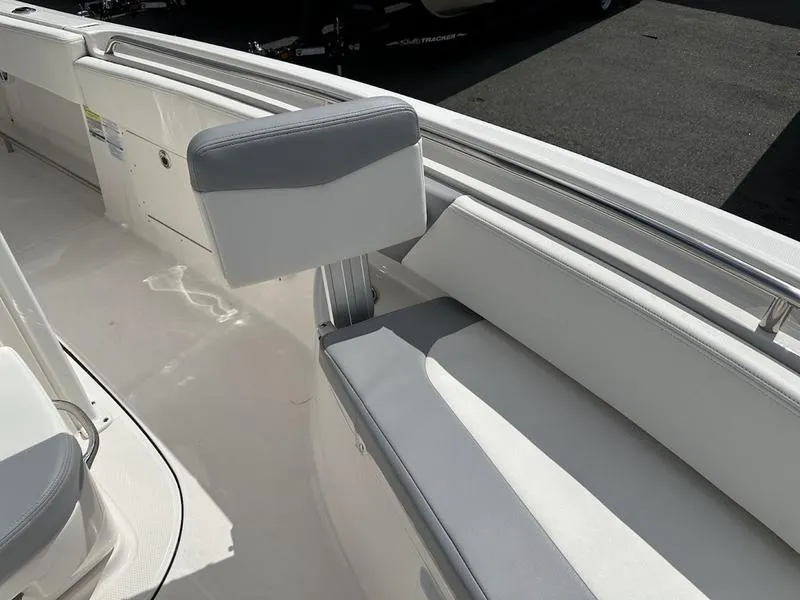 Slide: The Image of 2022 Robalo R242 boat interior with white and gray seating. - 13