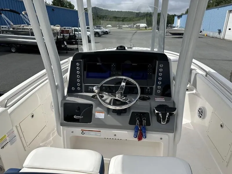Slide: The Image of 2022 Robalo R242 boat dashboard with steering wheel and control panel. - 22