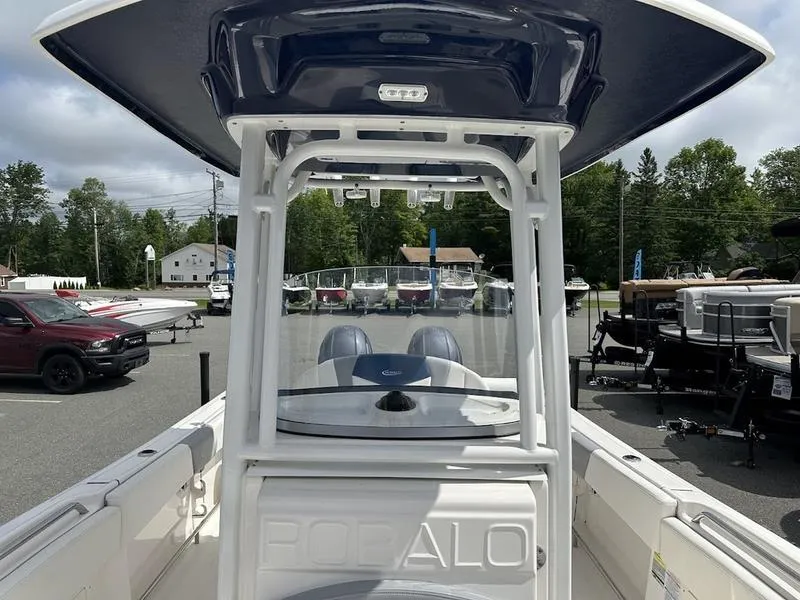 Slide: The Image of 2022 Robalo R242 boat on display at a dealership. - 4