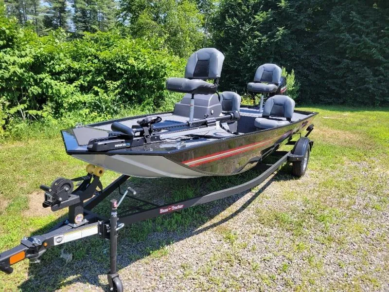 Slide: The Image of 2024 Tracker BT CLASSIC XL fishing boat on a trailer in a grassy area. - 4