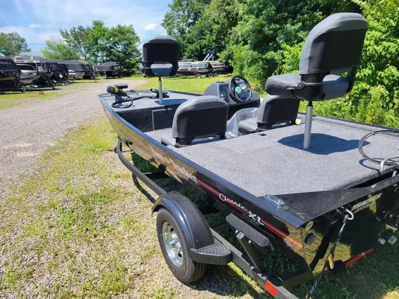 Slide: The Image of 2024 Tracker BT CLASSIC XL fishing boat on a trailer in an outdoor setting. - 9