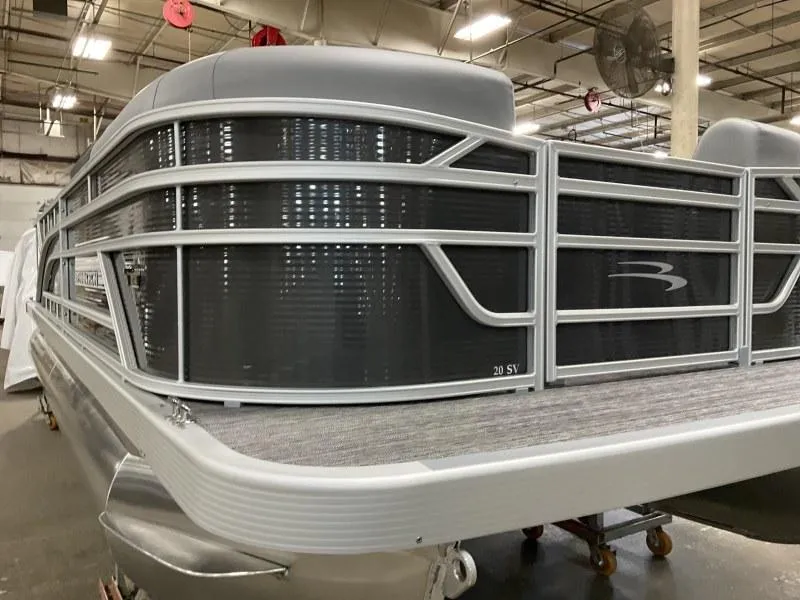 Slide: The Image of 2024 Bennington 20 SVSR pontoon boat in a showroom, showcasing sleek design and modern features. - 10