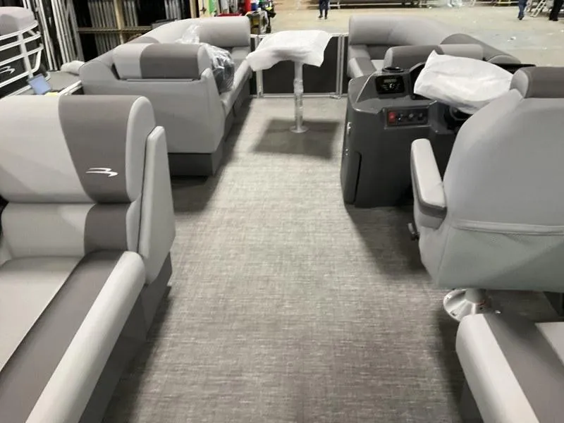 Slide: The Image of 2024 Bennington 20 SVSR pontoon boat interior with gray seating and helm. - 13