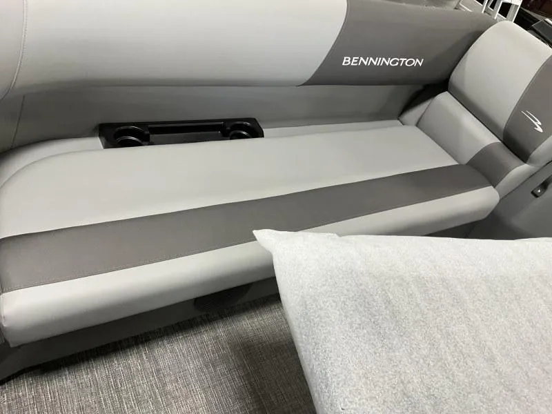 Slide: The Image of 2024 Bennington 20 SVSR boat interior seating with cup holders, featuring gray upholstery. - 3