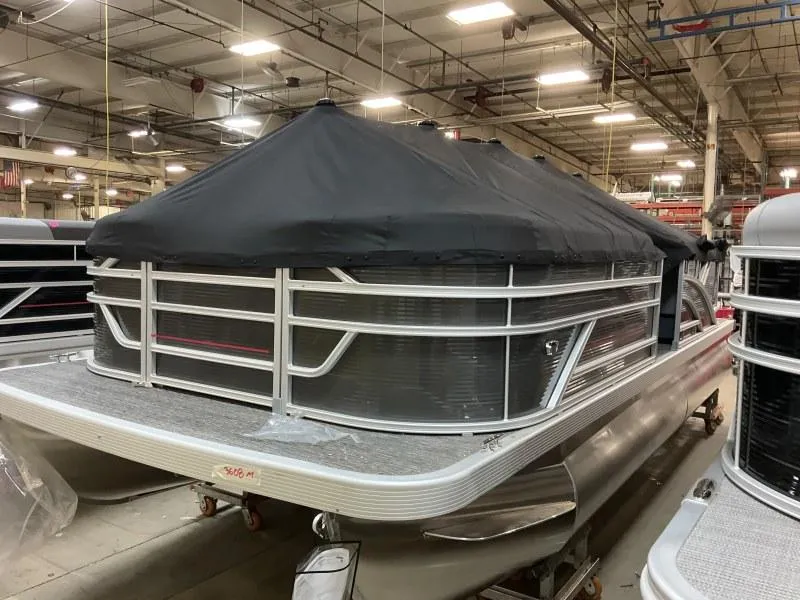 Slide: The Image of 2024 Bennington 20 SVSR pontoon boat with cover in a factory setting. - 5