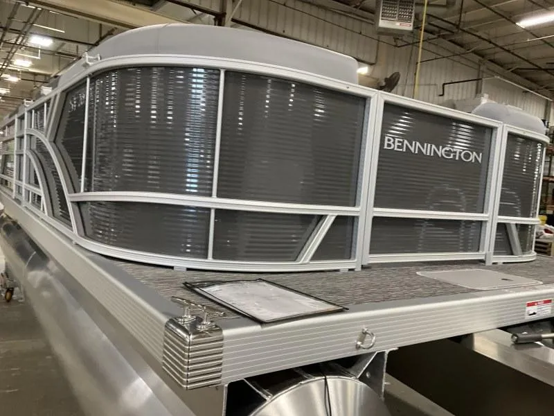 Slide: The Image of 2024 Bennington 20 SVSR pontoon boat in a warehouse setting. - 7
