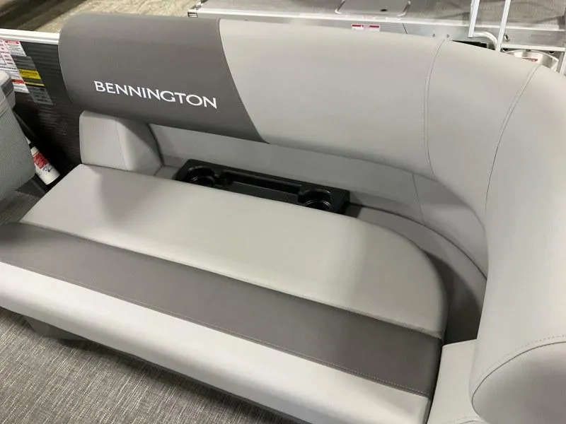Slide: The Image of 2024 Bennington 20 SVSR boat seating with gray upholstery and integrated cup holders. - 8