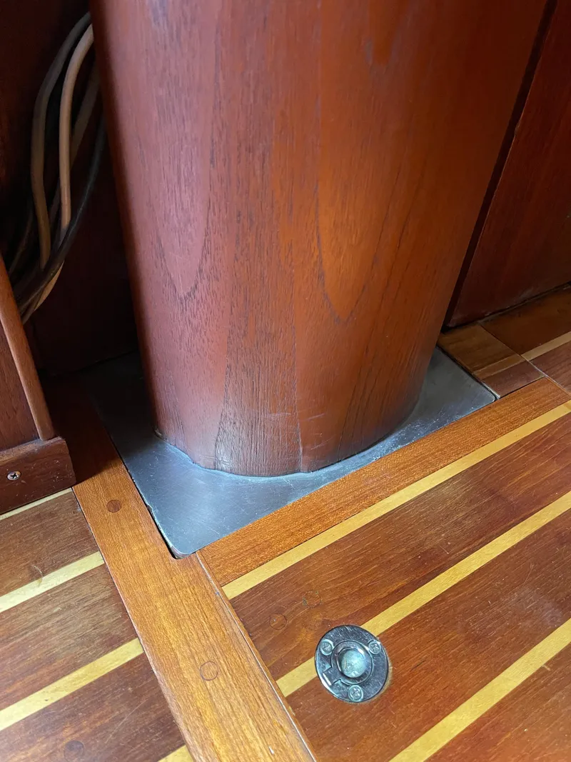 Slide: The Image of Wooden interior of 1978 CAL 2-39 sailboat, featuring mast support and polished floor. - 13