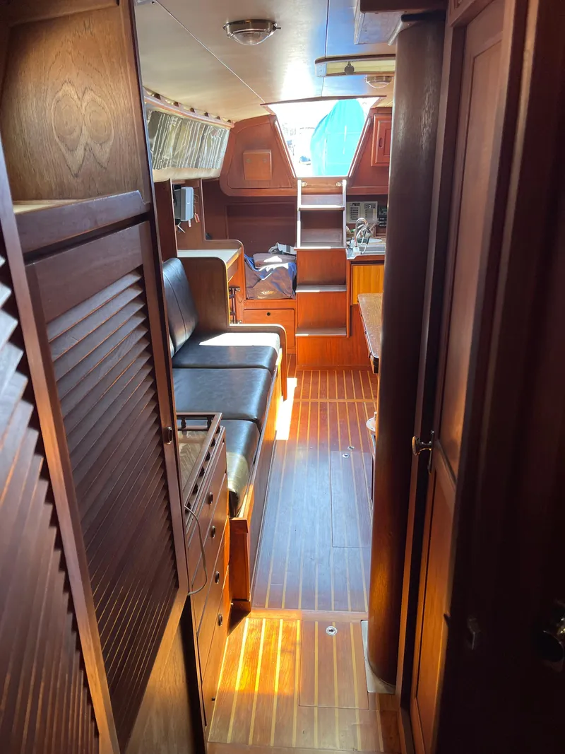 Slide: The Image of 1978 CAL 2-39 yacht interior with wooden finish and seating area. - 14