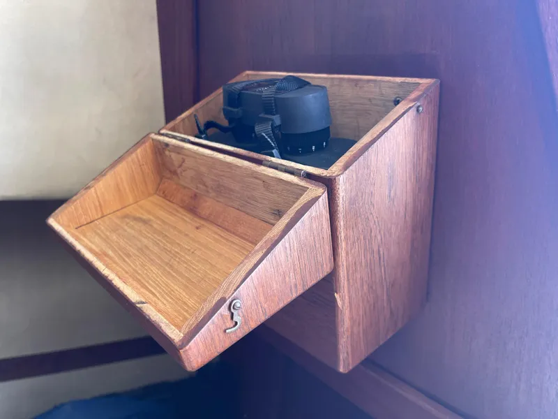 Slide: The Image of Wooden storage box on 1978 CAL 2-39 boat, featuring a small fan inside. - 19